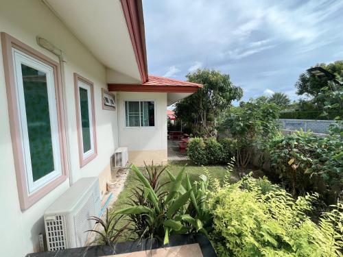 a view of a house with a garden at Home JANO in Cha Am