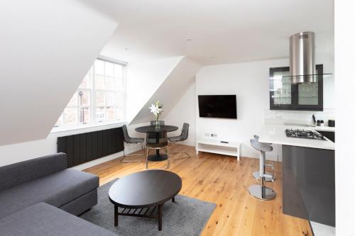 a living room with a couch and a table at Hampden Apartments - The William in Eton