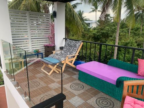 a balcony with a couch and a chair at Samui Dreams Seaview Villa - Bangrak Beach - with Private Pool in Koh Samui 