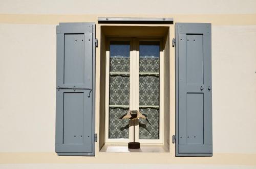an open window with a teddy bear behind it at La Fabbrica Delle Idee in Fonte