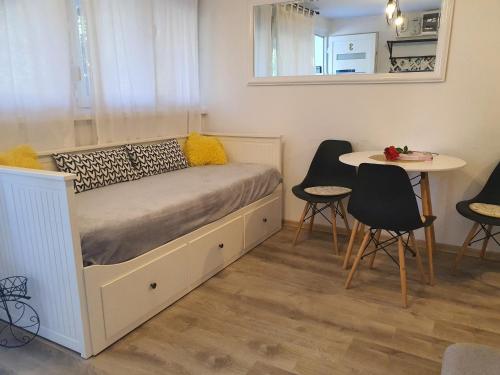 a bedroom with a bed with a table and chairs at Aparman Jež 3 De Lux in Karlovac
