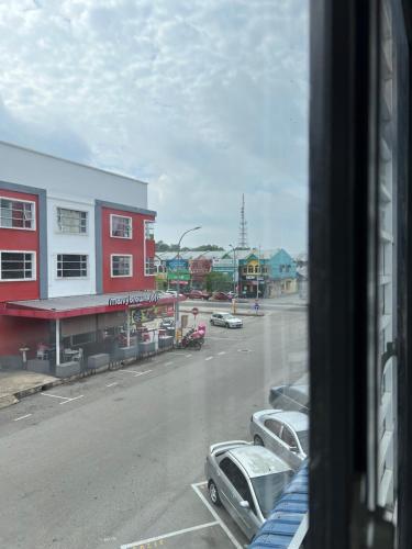 a view from a window of a street with cars at Ourstay Nadi Kota in Bandar  Pusat Jengka