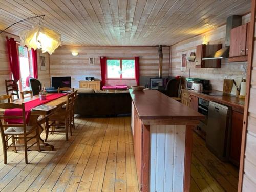 une cuisine et une salle à manger avec une table et des chaises dans l'établissement Chalet 8-10 personnes sur la station des Rousses, à Lamoura