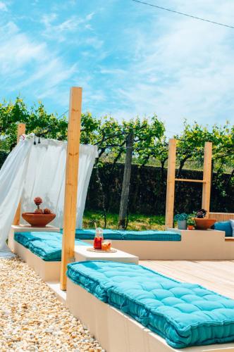 a couple of beds sitting on a patio at Just Like Home - Casa Antonio em Paredes de Coura in Paredes de Coura