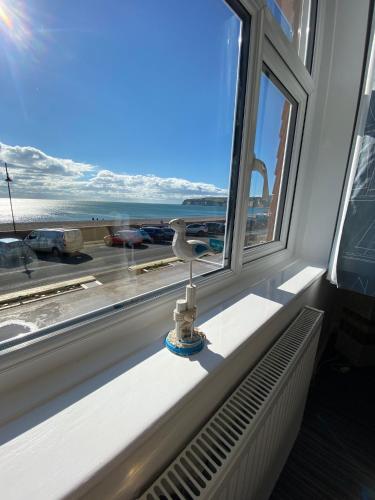 a window with a radiator and a view of the ocean at Mariners Hotel in Seaton