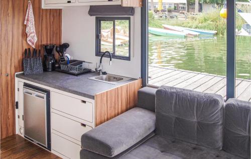 a kitchen in a boat with a sink and a table at 1 Bedroom Awesome Ship In Brandenburg in Brandenburg West