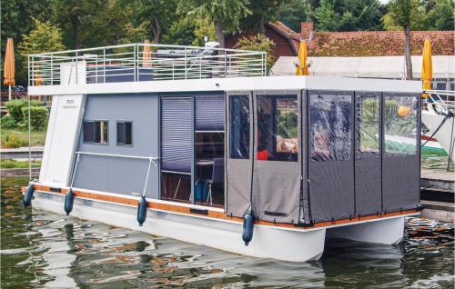 a small boat is docked on the water at 1 Bedroom Awesome Ship In Brandenburg in Brandenburg West