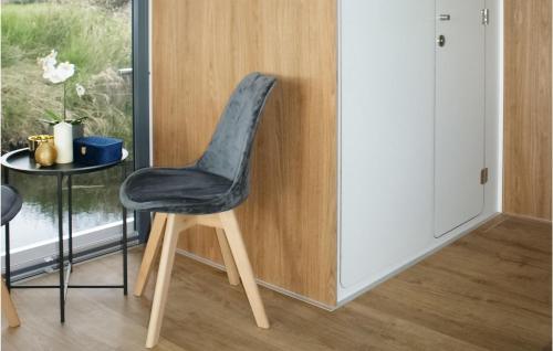 a black chair in a room with a table at 1 Bedroom Awesome Ship In Brandenburg in Brandenburg West