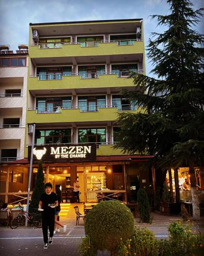 a person walking in front of a building at Vila Vadeha in Pogradec