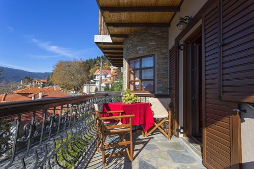 a patio with a table and chairs on a balcony at Giataki in Elati Trikalon