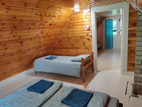 a room with a bed and a wooden wall at Cosy Holiday Home with sauna for family vacation 