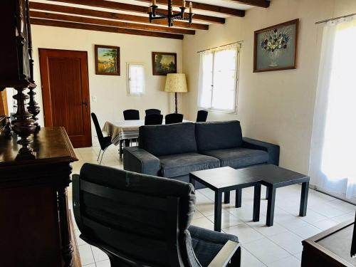 a living room with a couch and a table at Maison Basque T4 à Espelette : 5 adultes + 2 enfants, Internet, Jardin, Animal OK - FR-1-495-2 in Espelette