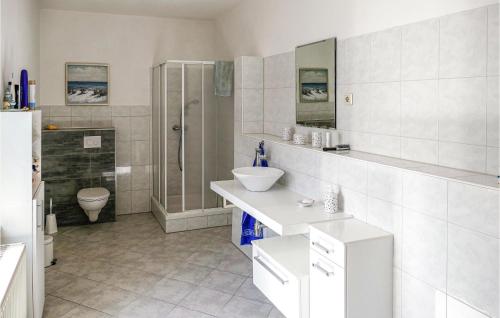 a white bathroom with a sink and a shower at 2 Bedroom Awesome Home In Kalbe- Milde -kakerbec 