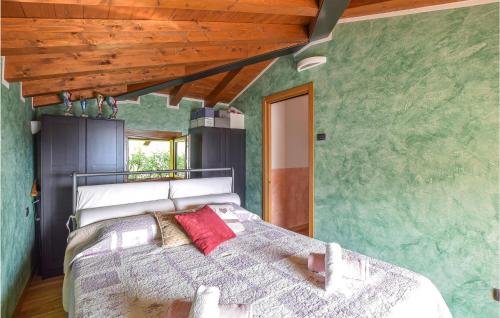 a bedroom with a bed in a room with green walls at 4 Bedroom Amazing Home In Pilzone-Iseo in Pilzone