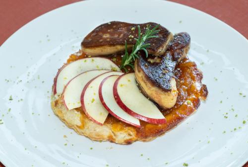 a white plate with a sandwich with apples and meat at Hôtel Causse Comtal Rodez, The Originals Relais in Gages-le-Haut