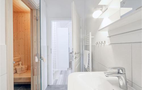 a white bathroom with a sink and a mirror at Beautiful Home In Krems Iiwarderbrück in Göls