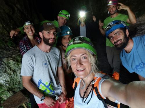 a group of people wearing helmets standing in a cave at Sveri Adventure Camp in Chiatʼura