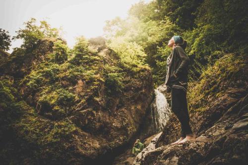 a woman standing on a rock on a mountain at Sveri Adventure Camp in Chiatʼura