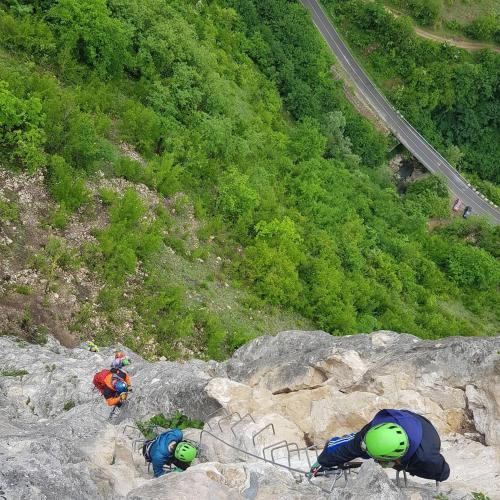 two people are climbing on a rocky mountain at Sveri Adventure Camp in Chiatʼura