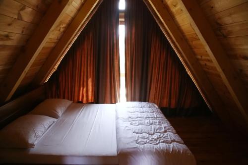 a bedroom with a bed in front of a window at Mountain Villas Žabljak in Žabljak