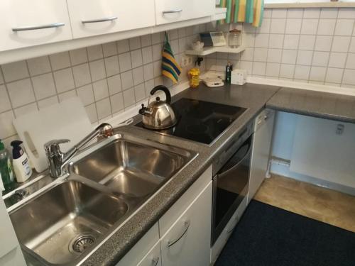 a kitchen sink with a tea kettle on top of it at Spacious Roof Top Maisonett Apartment in PRIEN at Lake Chiemsee in Stock