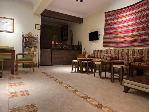 a living room with a couch and a table at Hotel Euphrat Nemrut in Karadut