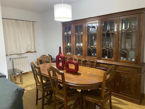 a dining room table with chairs and a large wooden cabinet at Congidouro in Freixo de Espada à Cinta