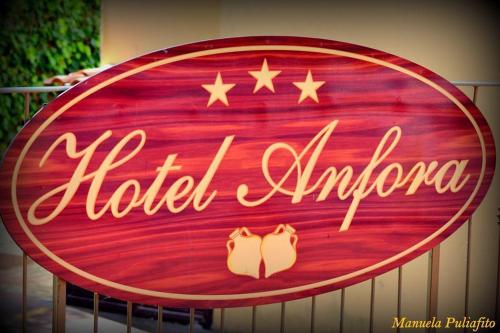 a sign for a hotel entrance with two shoes on it at Hotel Anfora in Capoliveri