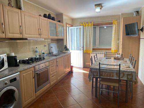 a kitchen with a table and a dining room at Congidouro in Freixo de Espada à Cinta