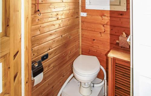 a small bathroom with a toilet and wooden walls at Stunning Ship In Brandenburg With Lake View in Kützkow