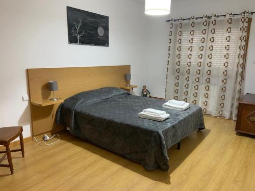 a bedroom with a bed with two towels on it at Congidouro in Freixo de Espada à Cinta