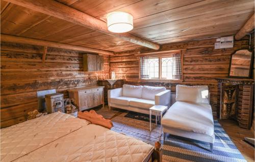 a bedroom in a log cabin with a bed and a couch at 2 Bedroom Amazing Home In Mora-nuns 