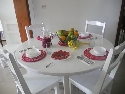 a white table with a bowl of fruit on it at Villa Kikiriki in Kigali