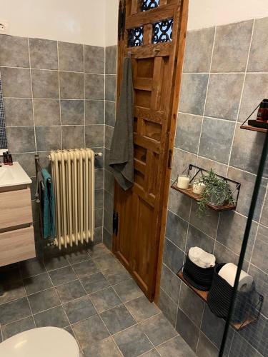 a bathroom with a toilet and a heater in it at Casas Demi Dos in Vélez Blanco