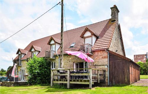 an old house with a pink umbrella in front of it at Lovely Home In Vire Normandie With Wifi in Saint-Martin-de-Tallevende