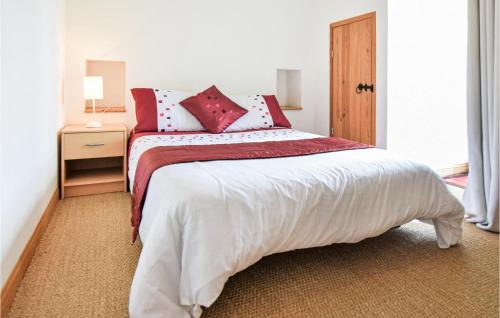 a bedroom with a large bed with red and white pillows at Lovely Home In Vire Normandie With Wifi in Saint-Martin-de-Tallevende