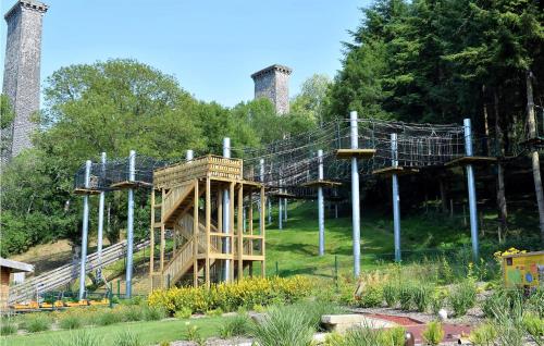 a roller coaster in a park with two smoke stacks at Lovely Home In Vire Normandie With Wifi in Saint-Martin-de-Tallevende