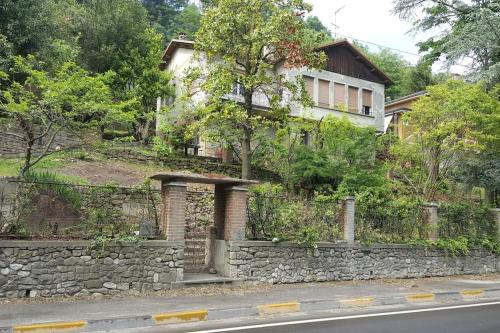 a stone wall in front of a house at Villa Bersani in CastellʼArquato