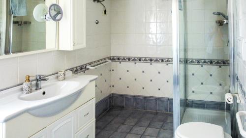 a bathroom with a sink and a shower at Villa Verde in Procchio