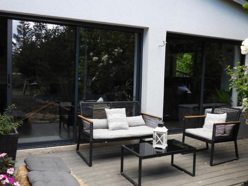 a patio with two chairs and a coffee table at La suite Mélusine - SPA du Souffle du Saule in Buhl-Lorraine