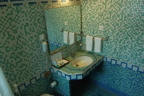 a bathroom with a sink and a mirror at The Meadows Resort and Spa in Aurangabad