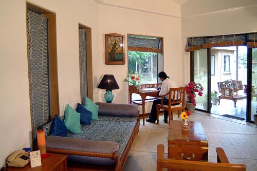 a person sitting at a table in a living room at The Meadows Resort and Spa in Aurangabad