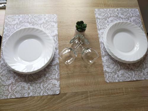 two white plates sitting on top of a table at Cezar in Arandjelovac