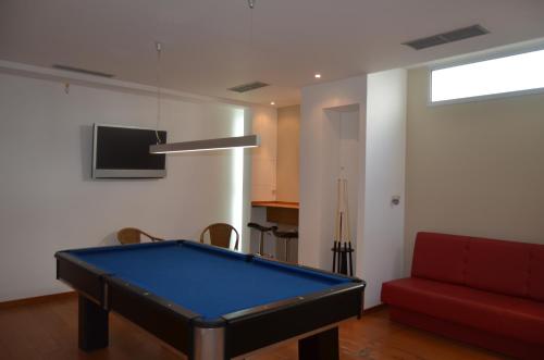 
a living room filled with furniture and a tv at Madeira Bright Star by Petit Hotels in Funchal
