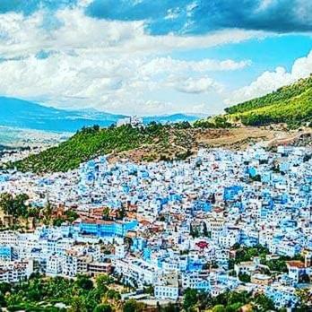 a view of a city with blue buildings on a hill at Casa Plasa Grande chefchaouen in Chefchaouene