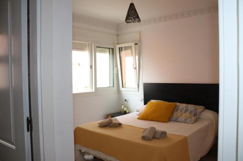 a bedroom with a bed with two slippers on it at Apartamento frente al mar in Radazul