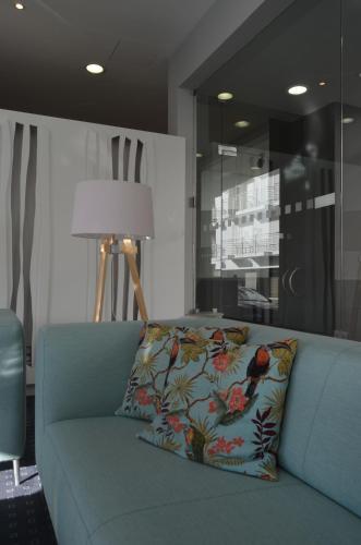 a blue couch with a pillow on it in a room at Madeira Bright Star by Petit Hotels in Funchal