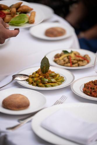 a table with white plates of food on it at Riad Fes - Relais & Châteaux in Fès