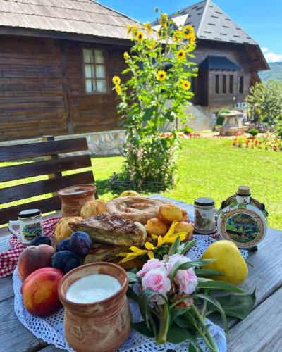 a picnic table with a plate of food on it at ETNO SELO VRANEŠA Zlatar in Nova Varoš