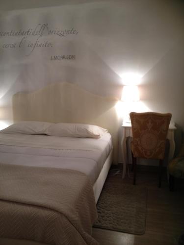 a bedroom with a bed and a desk with a lamp at La Dimora del Conte in Pescara